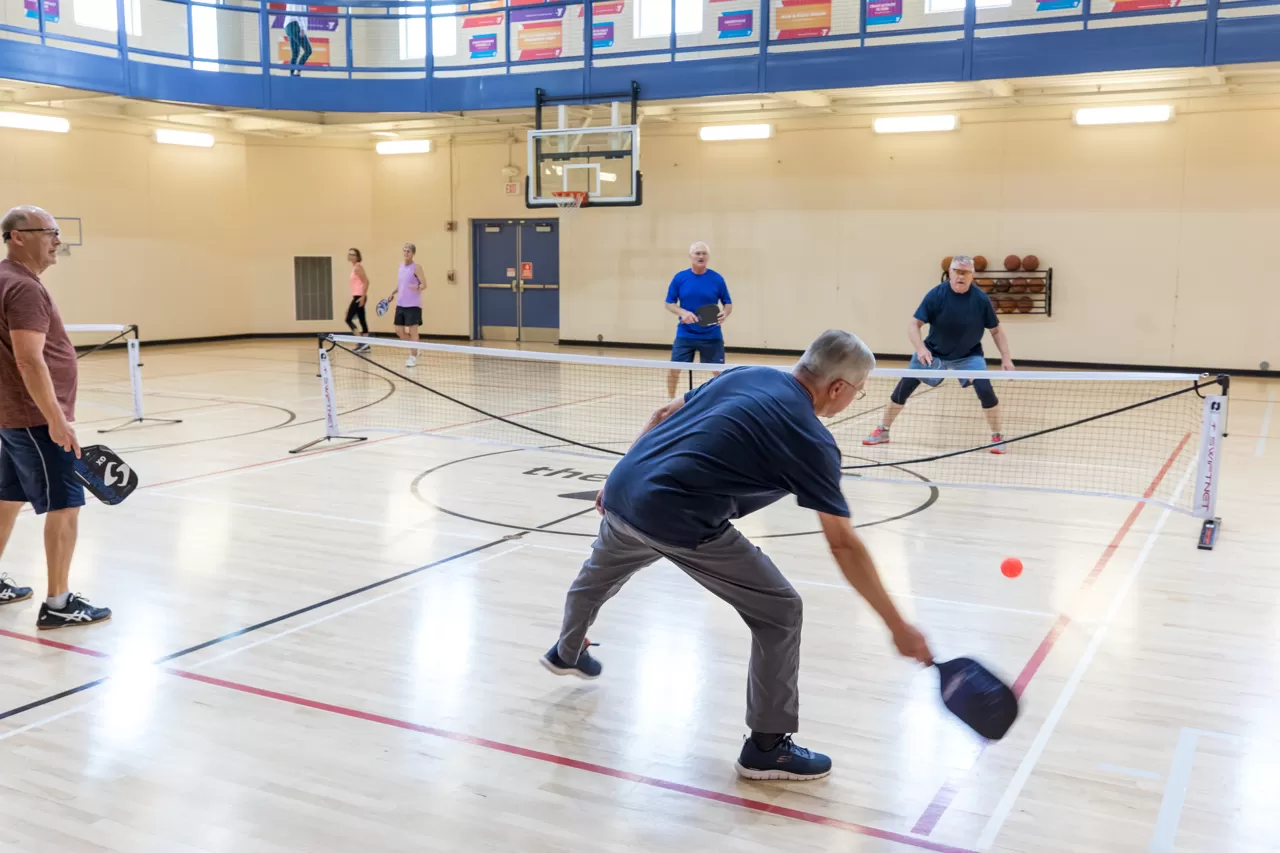 group of friends playing pickleball