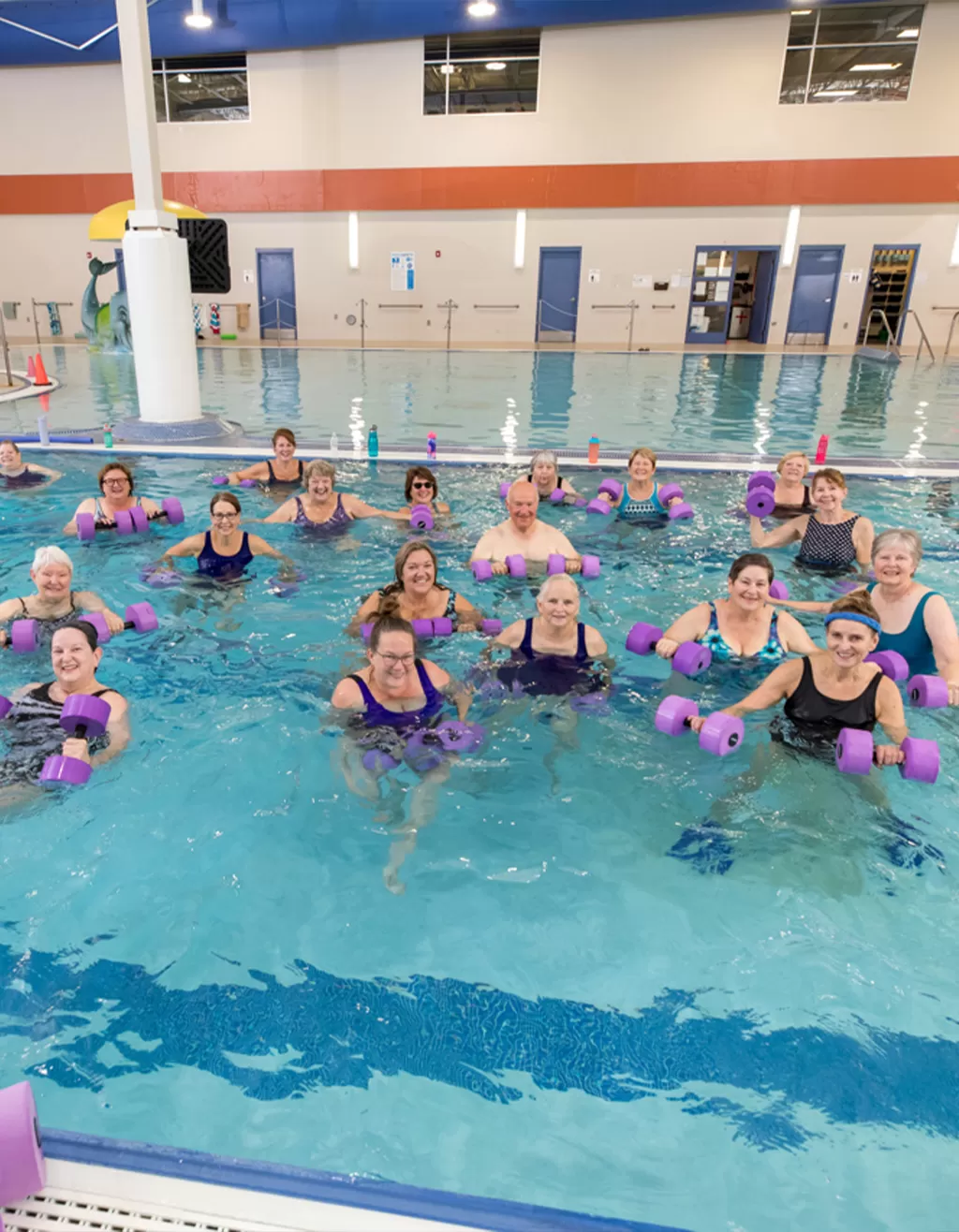 group of people in a water aerobics class
