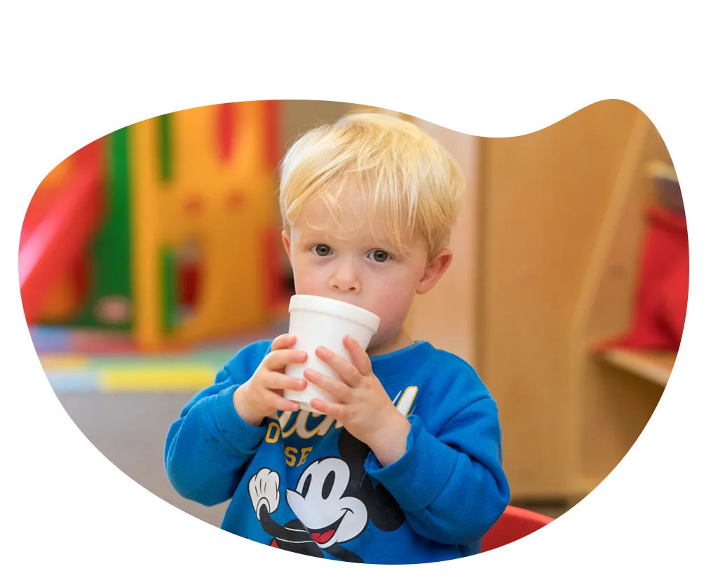 YMCA toddler drinking out of a cup