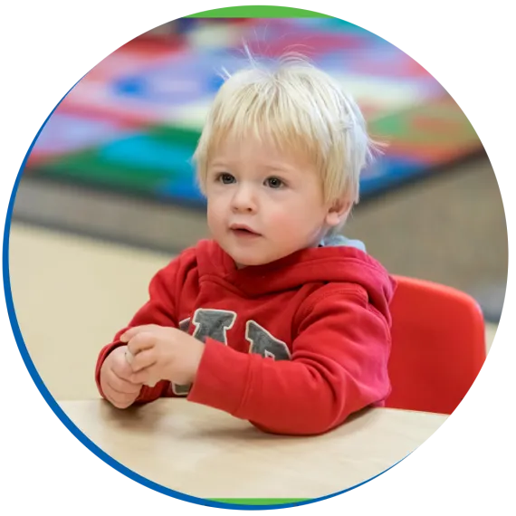 child sitting in a YMCA classroom