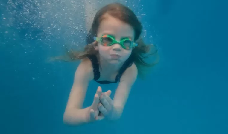 girl swimming under water