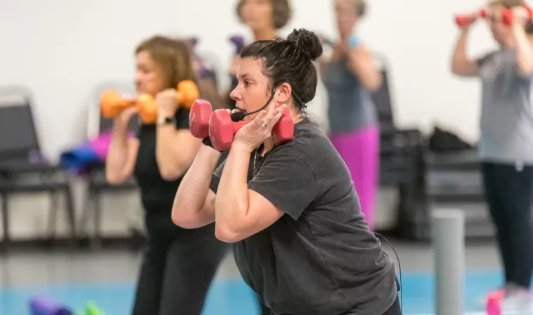 YMCA instructor leading a group exercise class