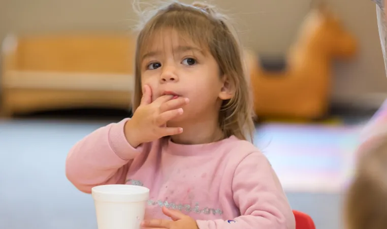 child eating snack at the YMCA
