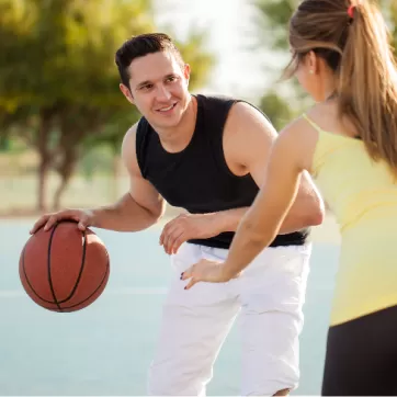 mand and woman playing basketball
