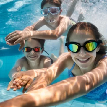 3 kids swimming underwater