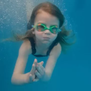 girl swimming under water