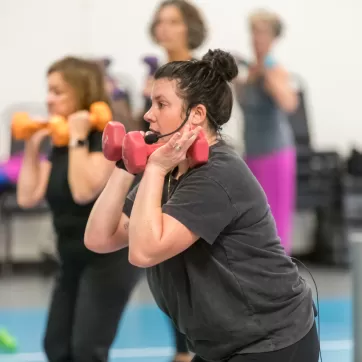 YMCA instructor leading a group exercise class