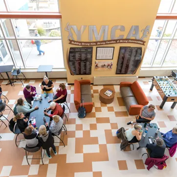 group of people sitting in the YMCA lobby