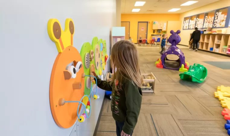 child playing with toys in child care center