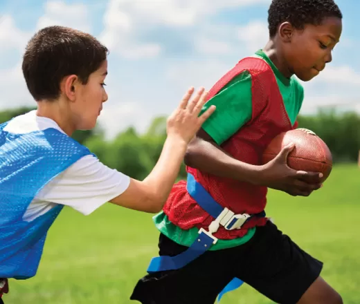 2 kids playing flag football